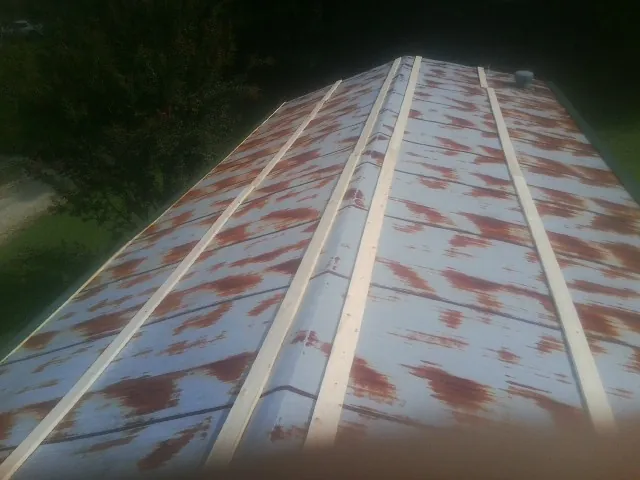 Rusted metal roof panels with new wood purlins before replacement — Storm Damage Roof Repair in Salkum by Roofing Brothers
